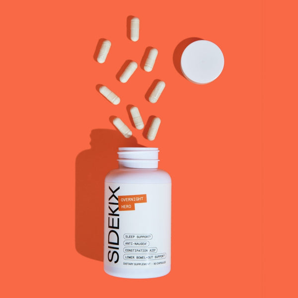 Closeup of Sidekix Dietary Supplement bottle, Overnight Hero product, open with capsules spread on orange background